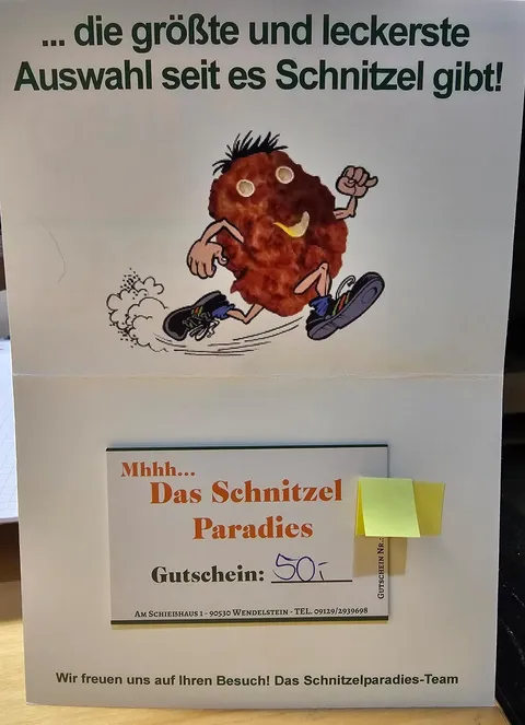 Ein Gutschein für ein Essen in der Schnitzelbude